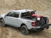 2023-ford-maverick-tremor-press-photos-exterior-016-off-road-rear-three-quarters-dirt-bike-loaded-into-bed-tailgate-adjusted-position