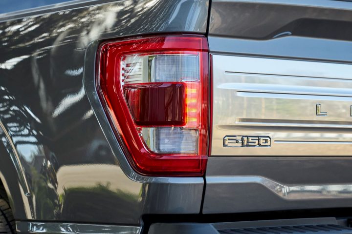 A photo showing the 2021 Ford F-150 from a rear three quarters angle.