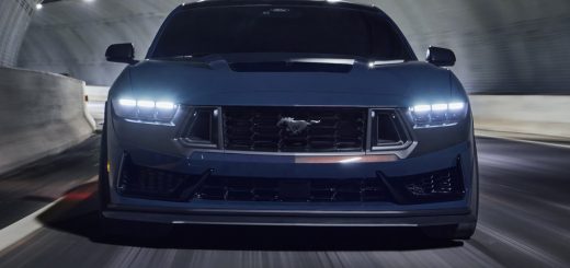 2024 Ford Mustang Dark Horse front view with headlights on.