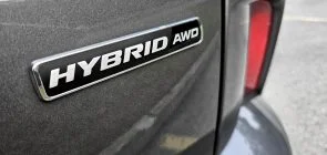 A photo showing the exterior of a 2023 Ford Escape Hybrid decklid badge.