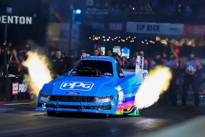 Photo of Bob Tasca III driving his NHRA Ford Mustang in a drag race, shown from a front three-quarters angle. Tasca was upset with an ad from Fox claiming IndyCar is the fastest motorsport on Earth. 