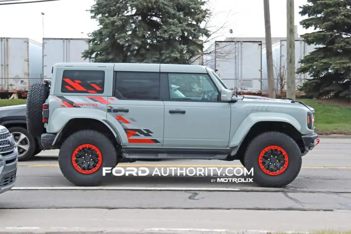 Side profile of 2024 Ford Bronco Raptor with Code Orange Appearance Package.
