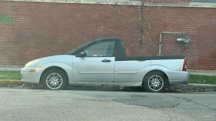 A side view of a custom Ford Focus pickup.