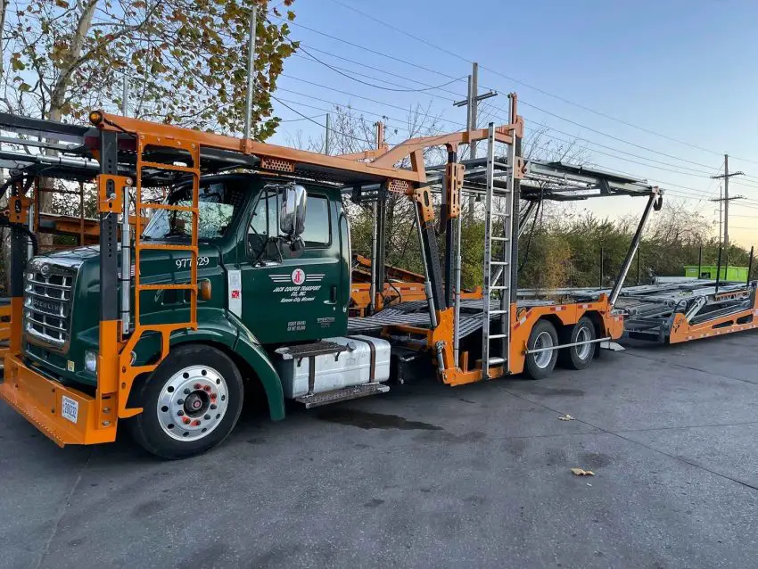 A photo showing the exterior of a Jack Cooper Auto Transport truck from a front three quarters angle.