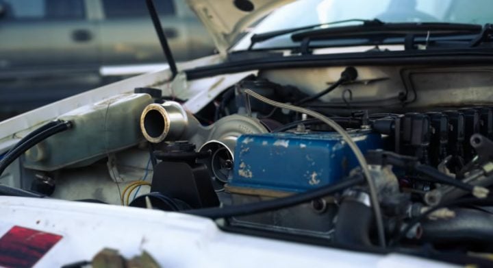 Video still of the 1989 Ford Falcon EA rescued by RRP Garage on YouTube, showing a view of the engine bay. 