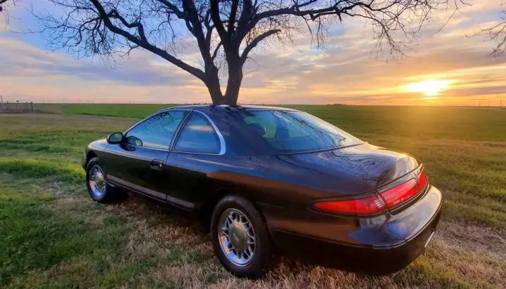 A photo showing the exterior of a 1997 Lincoln Mark VIII LSC from a rear three quarters angle.