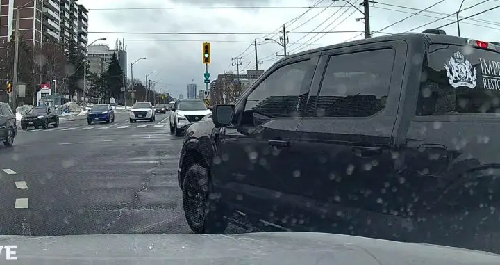 Video still of the offending 2024 Ford F-150 cutting off the cam car to make an illegal pass at a traffic light. 