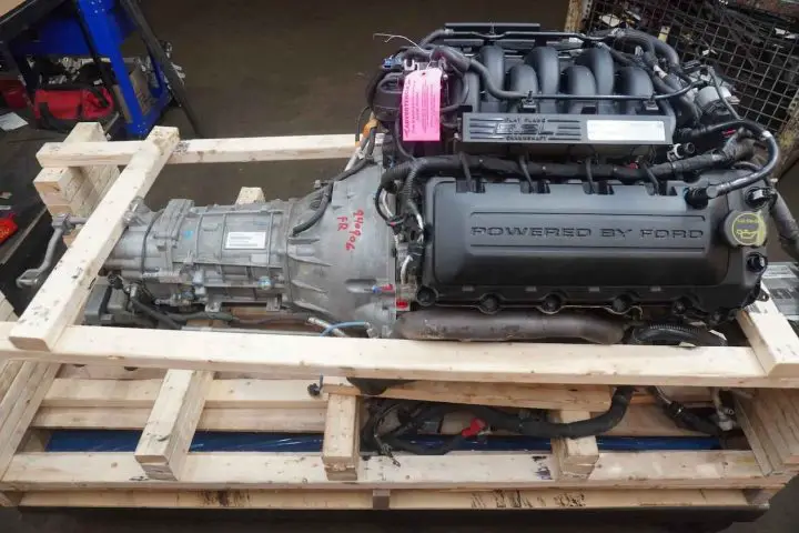 A photo showing the exterior of a Ford 5.2L V8 Voodoo engine and Tremec six-speed transmission from a side angle.