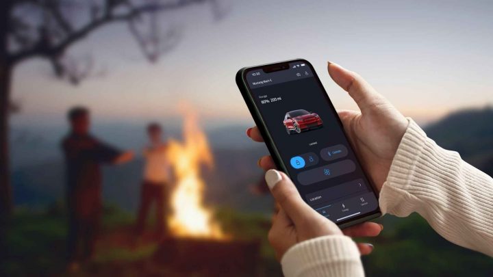 A photo showing an Apple iPhone running the FordPass app in Dark Mode.