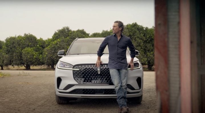 A photo showing Matthew McConaughey standing in front of a 2025 Lincoln Aviator in a new commercial.