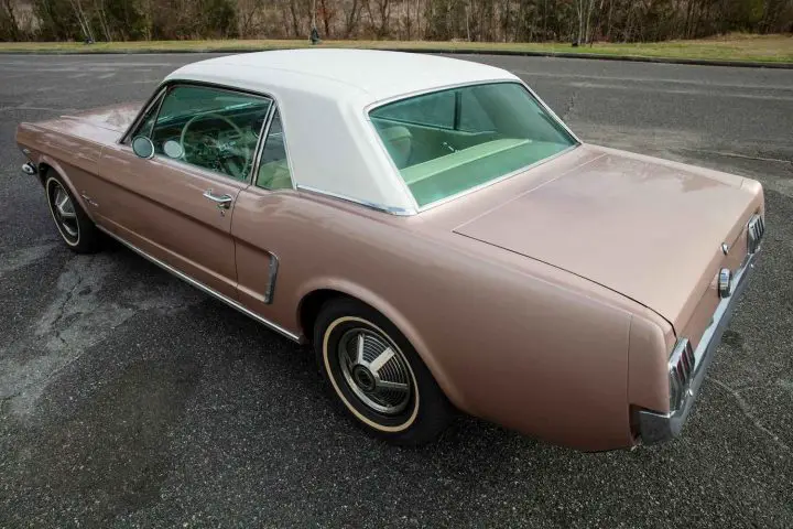 A photo showing the exterior of a 1965 Ford Mustang from a rear three quarters angle.
