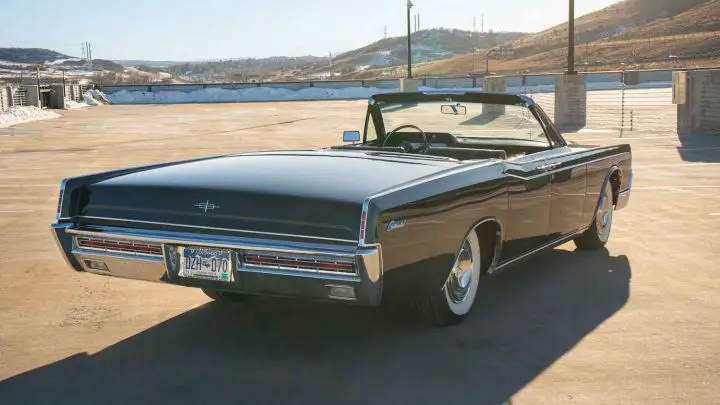 A photo showing the exterior of a 1967 Lincoln Continental from a rear three quarters angle.