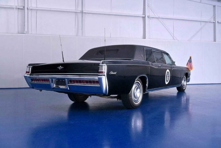 A photo showing the exterior of a 1969 Lincoln Continental limo from a rear three quarters angle.