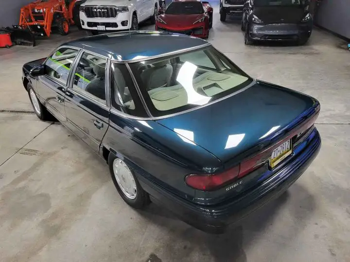 A photo showing the exterior of a 1995 Mercury Sable GS from a rear three quarters angle.