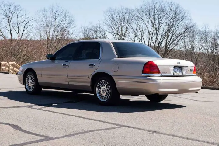 A photo showing the exterior of a 1998 Ford Crown Victoria from a rear three quarters angle.