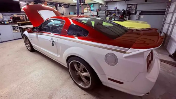 A photo showing the exterior of a custom SEMA 2007 Ford Mustang Roush build from a rear three quarters angle.
