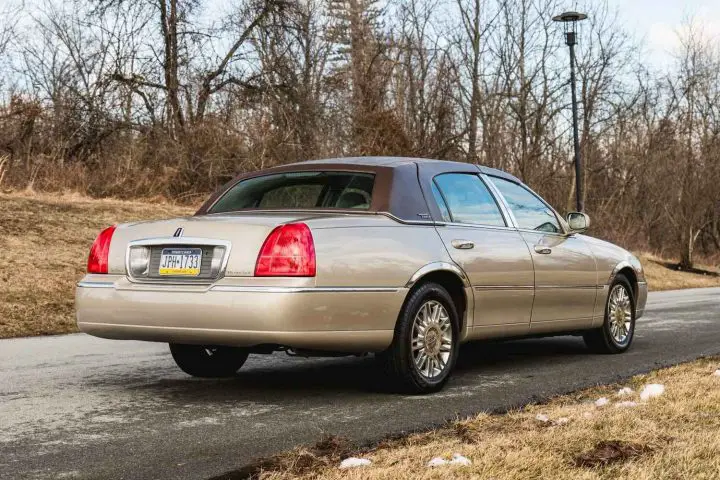 A photo showing the exterior of a 2009 Lincoln Town Car from a rear three quarters angle.