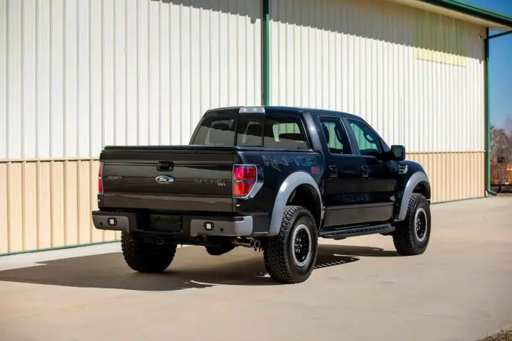 A photo showing the exterior of a 2014 Ford F-150 SVT Raptor from a rear three quarters angle.