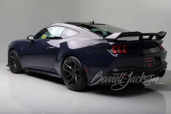 A photo showing the exterior of 2024 Ford Mustang Dark Horse VIN 001 from a rear three quarters angle.