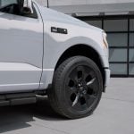 A photo showing the exterior of the 2025 Ford F-150 Lightning Platinum Dark Element Package from a front fender angle.