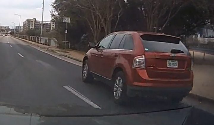 Video still of the Ford Edge that was rear ended while trying to avoid hitting a pedestrian at a stoplight in Austin, Texas.