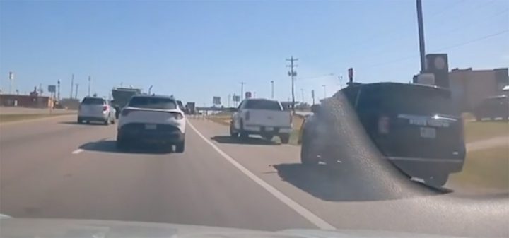 Video still of the Ford F-150 being pulled over for driving on the shoulder in traffic. 