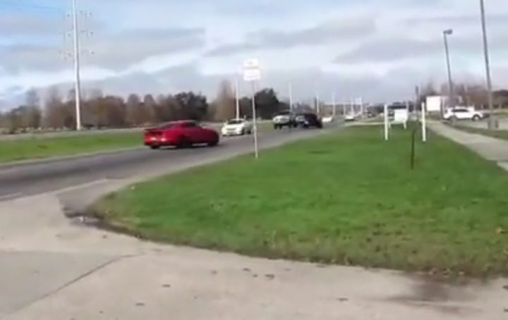Video still of the Ford Mustang as it spins out, almost hitting traffic as it leaves a car show. They managed to not crash, somehow. 