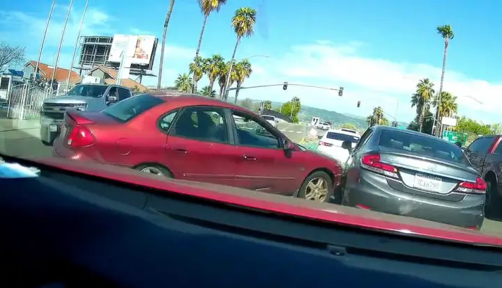 Video still of the Ford Taurus after it was struck by the Chevy Silverado, forcing it into a spin and striking a Honda. 