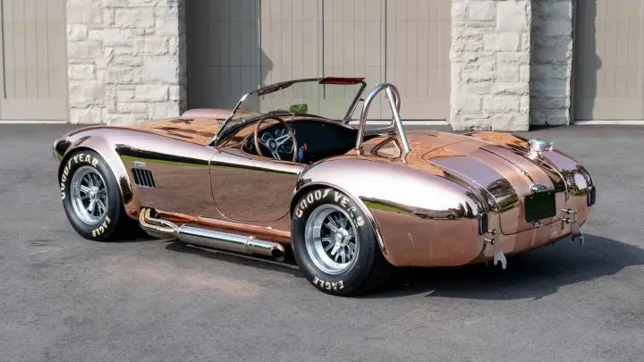 A photo showing the exterior of a 1965 Shelby Cobra CSX4000 Series Roadster from a rear three quarters angle.