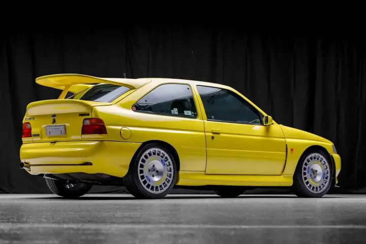 A photo showing the exterior of a 1996 Ford Escort RS Cosworth Lux from a rear three quarters angle.