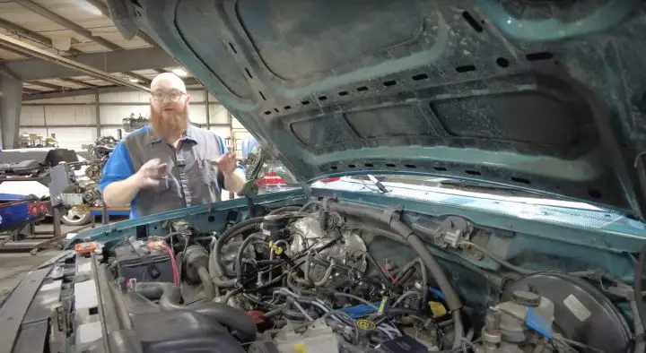 A photo showing the engine bay of a 1996 Ford F-150.