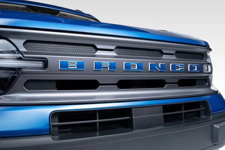 Photo showing a close up view of the 2025 Ford Bronco Sport Blue Free Wheeling Package grille, featuring blue Bronco lettering. This package is priced at $2,625.