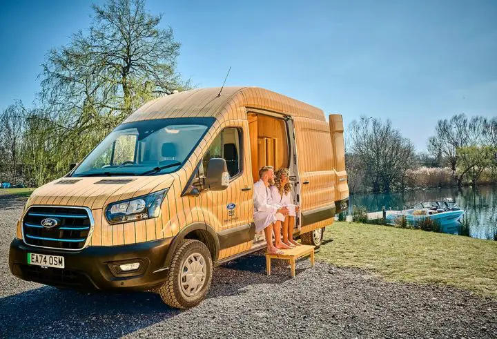 Photo of the Ford E-Transit Sauna van, seen from a front three quarters angle. This build was created by the Ford Pro Special Vehicle Team.