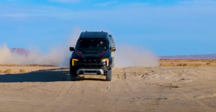 Video still of the Ford F-150 Raptor taking on some hills in a test with BigTime on YouTube. All things considered, it performed well against the Raptor T1+ race car. 