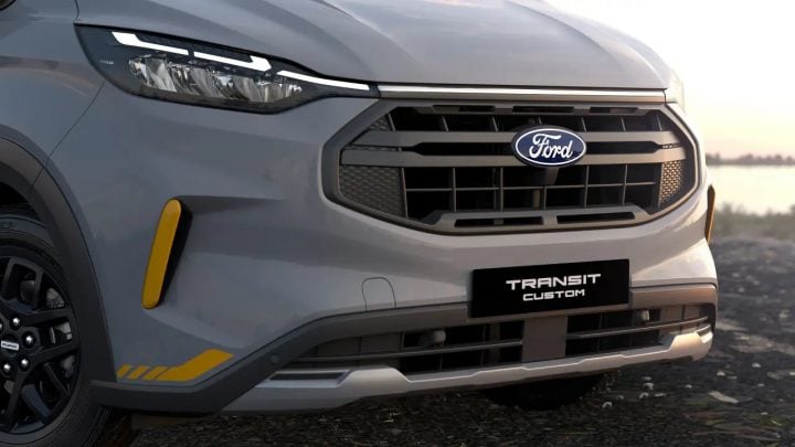 Close up of the Ford Transit Custom Trail front end, featuring yellow accents and a coast-to-coast lightbar. This model brings AWD to the Australian market. 