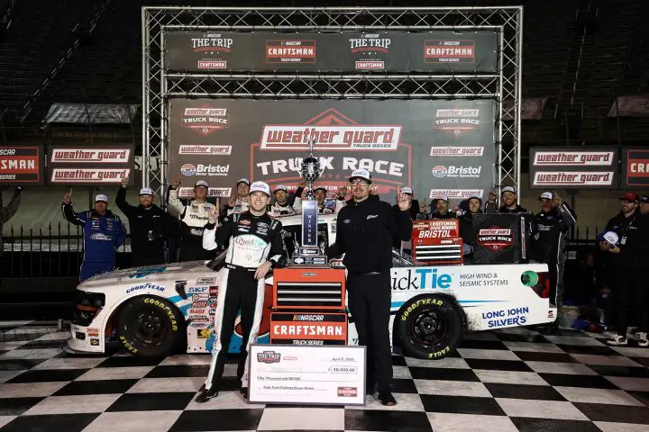 Photo of Chandler Smith posing in front of the No. 38 NASCAR Ford F-150 in Victory Lane at Bristol. The victory marked his first for Ford, along with the automaker's first this year. 