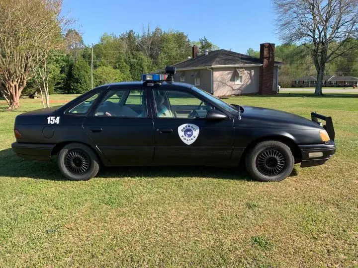 A photo showing the exterior of a 1987 Ford Taurus LX RoboCop replica from a side angle.