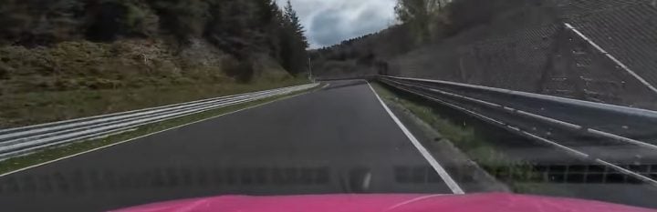 A video still from a dash-mounted camera showing the Ford Transit Custom driven by Shmee150 tearing around the Nürburgring. 