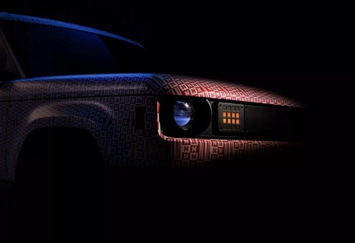 A teaser photo showing the exterior of the Slate Auto EV Pickup from a front angle.
