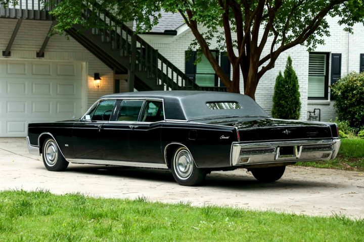 A photo showing the exterior of a 1967 Lincoln Continental limo used by Anheuser Busch from a rear three quarters angle.