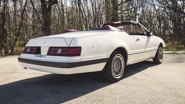 A photo showing the exterior of a 1984 Mercury Cougar convertible from a rear three quarters angle.