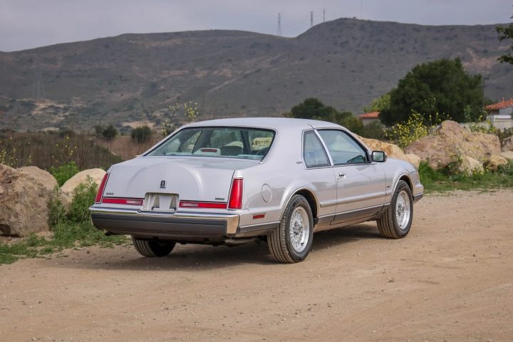 A photo showing the exterior of a 1991 Lincoln Mark VII LSC with 57k miles from a rear three quarters angle.