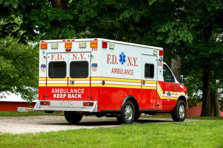 A photo showing the exterior of a 1993 Ford E-350 FDNY ambulance from a rear three quarters angle.