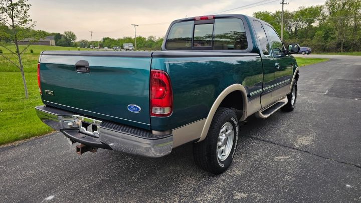 A photo showing the exterior of a 1997 Ford F-150 XLT from a rear three quarters angle.