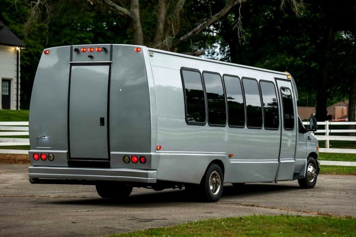 A photo showing the exterior of a 1999 Ford E-450 limo bus from a rear three quarters angle.