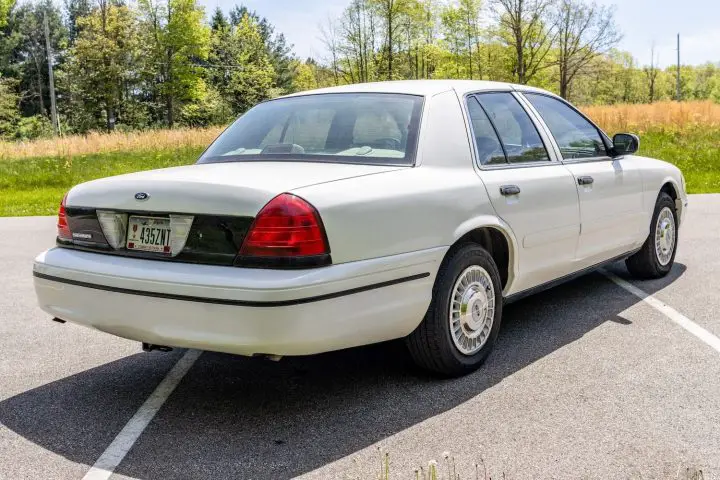 A photo showing the exterior of a 2000 Ford Crown Victoria Police Interceptor from a rear three quarters angle.