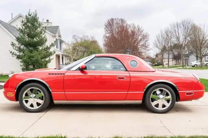 Photo showing a side view of the 2002 Ford Thunderbird for sale, which is nearly brand new with 7K miles racked up.