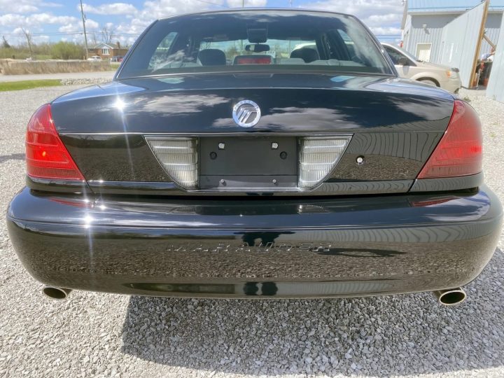 A photo showing the exterior of a 2003 Mercury Marauder with 26k miles from a rear angle.