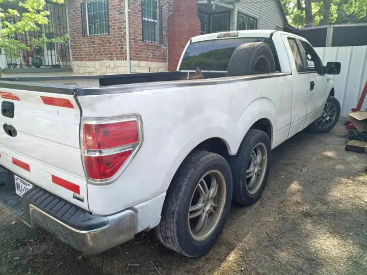 A photo showing the exterior of a 2010 Ford F-150 6x6 conversion from a rear three quarters angle.