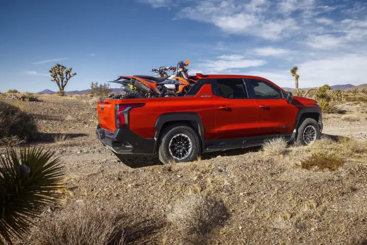 A photo showing the exterior of the 2026 Chevy Silverado EV Trail Boss from a rear three quarters angle.